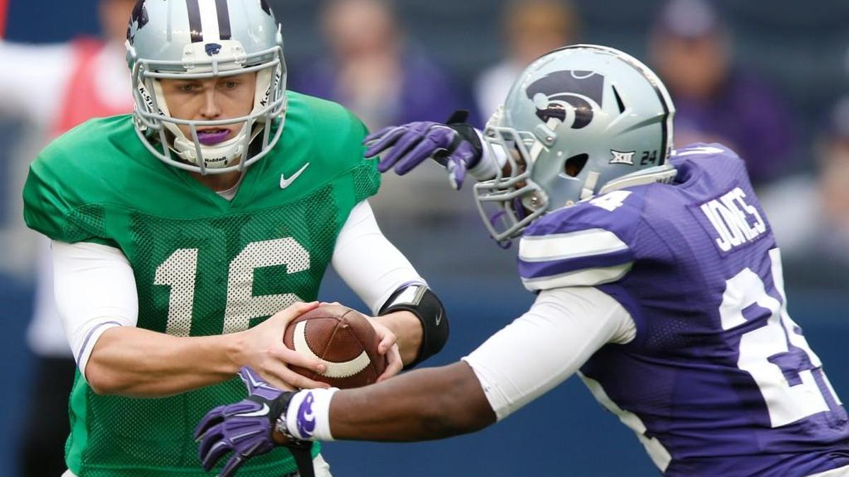 Quarterback Jesse Ertz hands the ball to Charles Jones.(April 25, 2015)