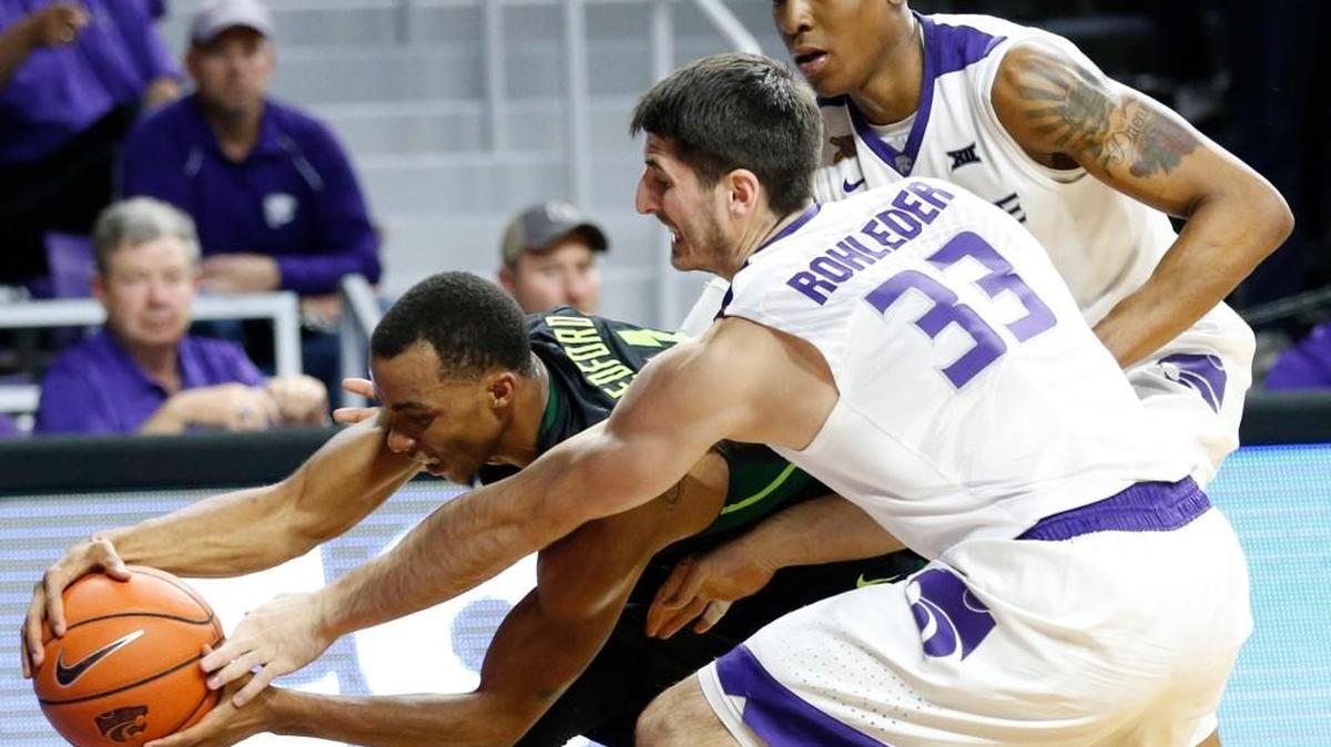 K-State guard Brian Rohleder and forward Wesley Iwundu try to steal the ball from Baylor guard Lester Medford Wednesday night late the game in Bramlage Coliseum.(February 10, 2016)