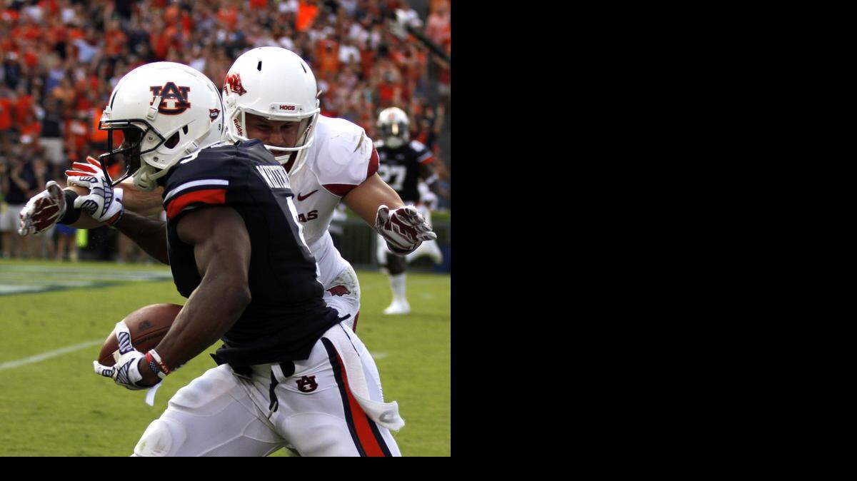 
Auburn defensive back Jermaine Whitehead intercepts a pass and returns it for a touchdown against Arkansas. (AP Photo/Butch Dill)
