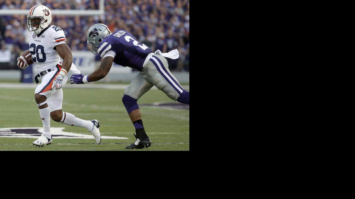 
Auburn running back Corey Grant tries to get past Kansas State defensive back Travis Green. (AP Photo/Charlie Riedel)
