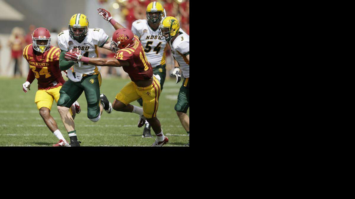 
North Dakota State quarterback Carson Wentz tries to break a tackle by Iowa State linebacker Jared Brackens. (AP Photo/Charlie Neibergall)
