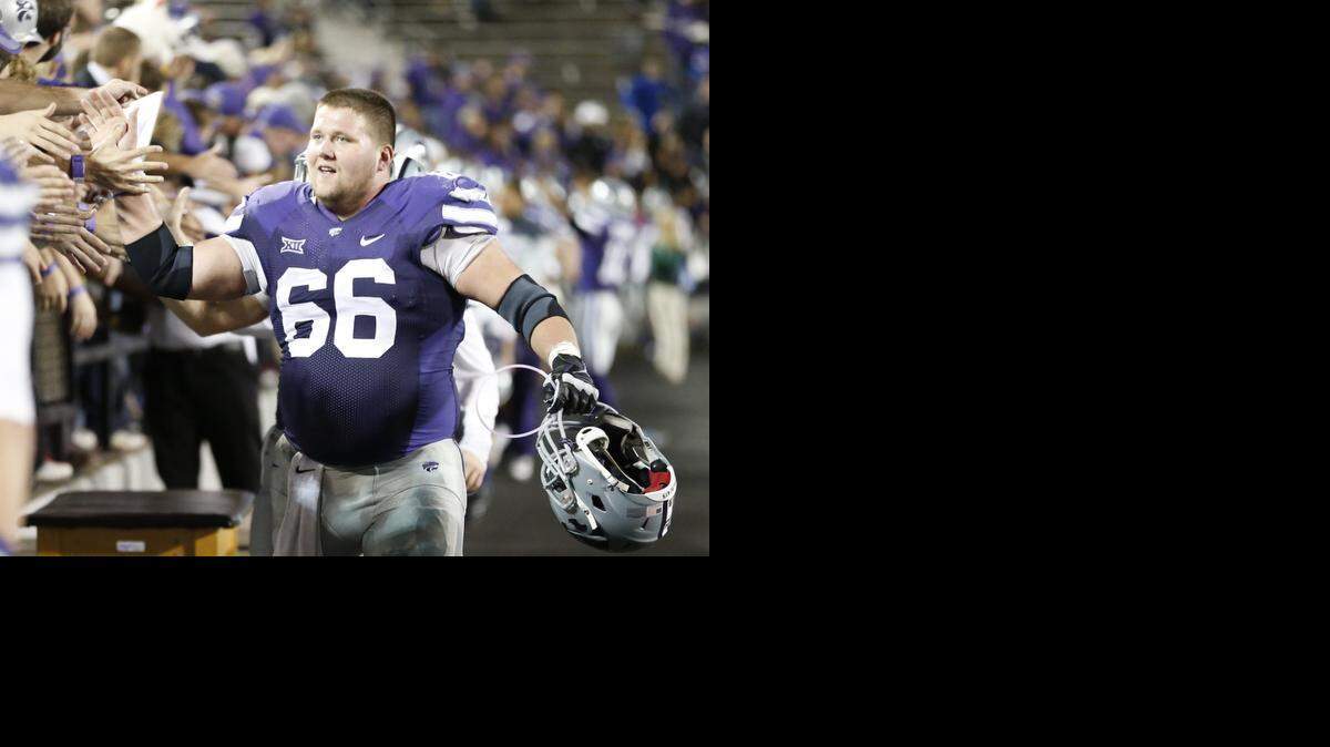 
K-State offensive lineman B.J. Finney makes his way around Snyder Family Stadium after the Wildcats defeated Kansas on Nov. 29.
