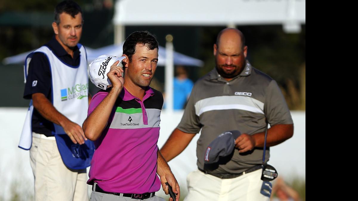 
Robert Streb (center) waved to the crowd after winning a three-way playoff during the final round of the McGladrey Classic golf tournament on Oct. 26 in St. Simons Island, Ga. Streb beat Brednon de Jonge (right) and Will MacKenzie. 

