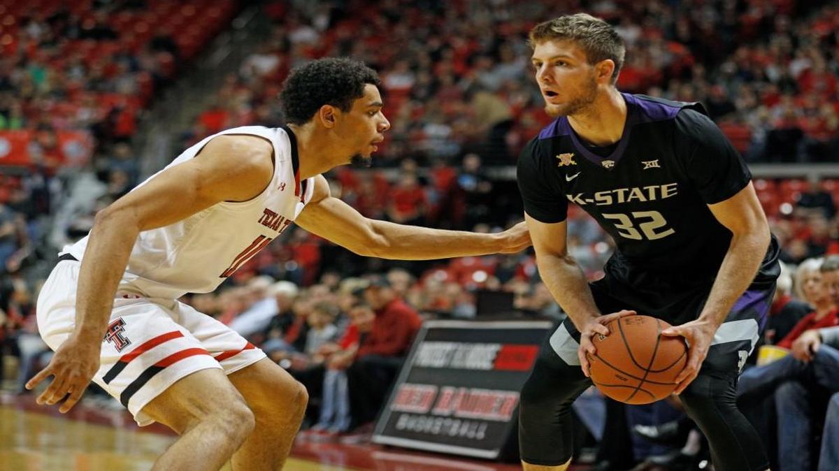 Kansas State's Dean Wade looks to pass the ball around Texas Tech's Zach Smith (11) during the first half Saturday in Lubbock, Texas.
