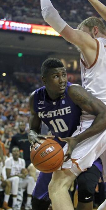 
Kansas State forward Malek Harris looks to pass around Texas forward Connor Lammert during the first half Saturday in Austin.
