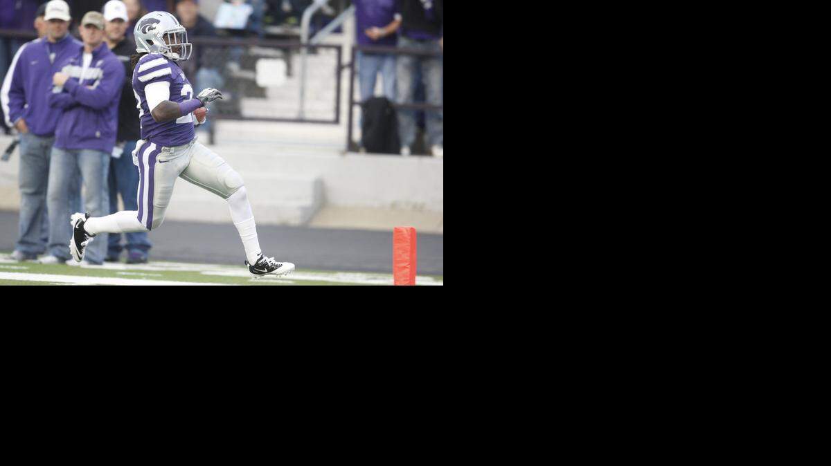 
K-State defensive back David Garrett (27) runs for a touchdown early in the first quarter after intercepting a 2011 Kent State pass. Garrett was killed early Saturday in a Cleveland shooting.
