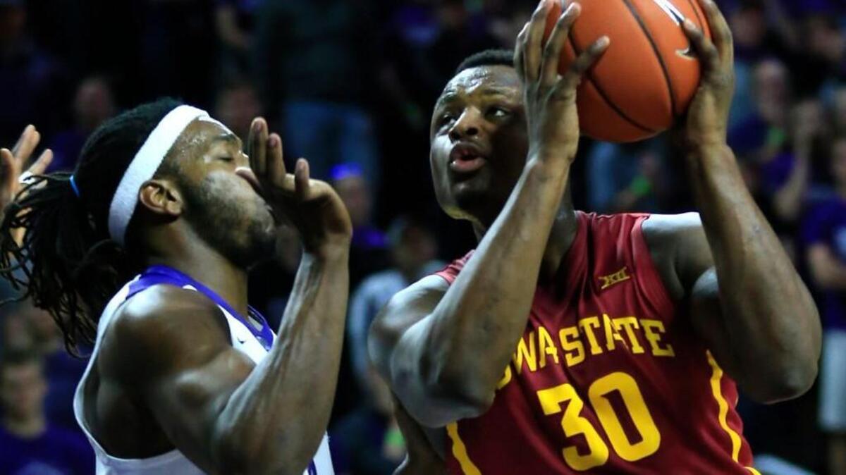 Iowa State guard Deonte Burton, right, drives on Kansas State forward D.J. Johnson during the first half Wednesday in Manhattan.