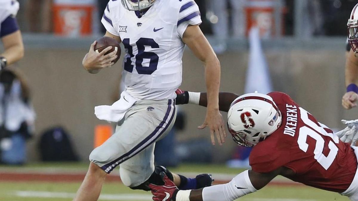 K-State quarterback Jesse Ertz (16) slips past Stanford linebacker Bobby Okereke (20) Friday evening.