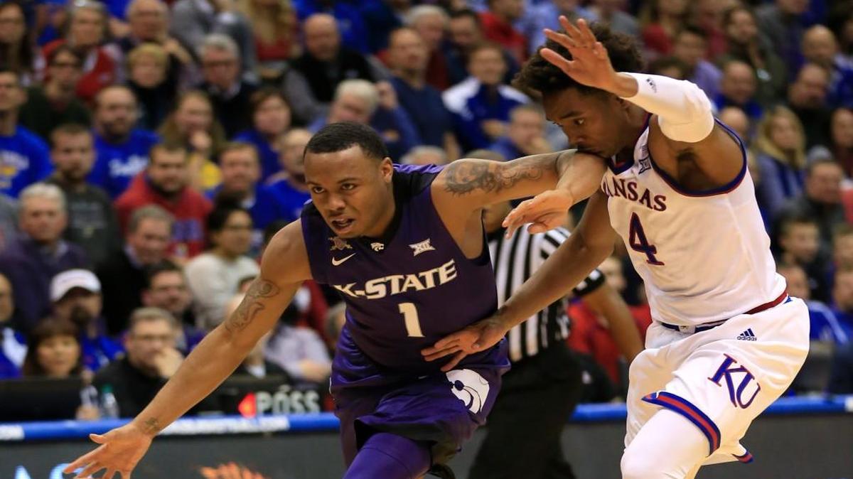 Kansas State guard Carlbe Ervin II slips past Kansas guard Devonte' Graham in Lawrence, Kan., Tuesday, Jan. 3, 2017. Kansas defeated Kansas State 90-88. (AP Photo/Orlin Wagner)