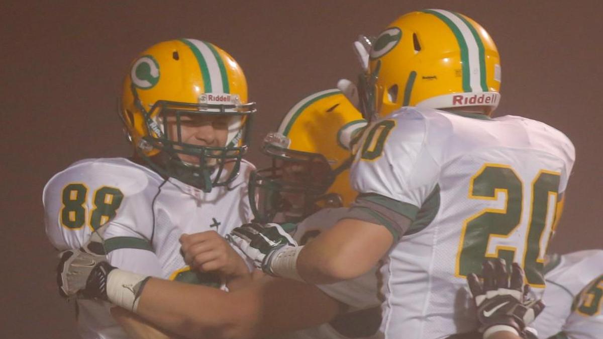 Brett Bell, left, celebrates a touchdown with Carroll.
