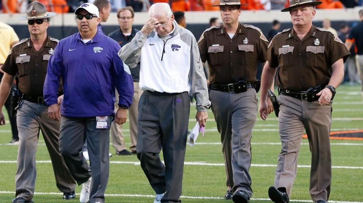 
K-State coach Bill Snyder walks off the field escorted by Oklahoma State troopers.(Oct 3, 2015)
