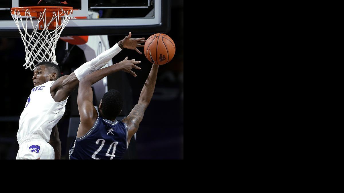 
Kansas State's Jevon Thomas, left, blocks a shot by Washburn's Stephon Drane during the second half of their exhibition game Sunday in Manhattan. 
