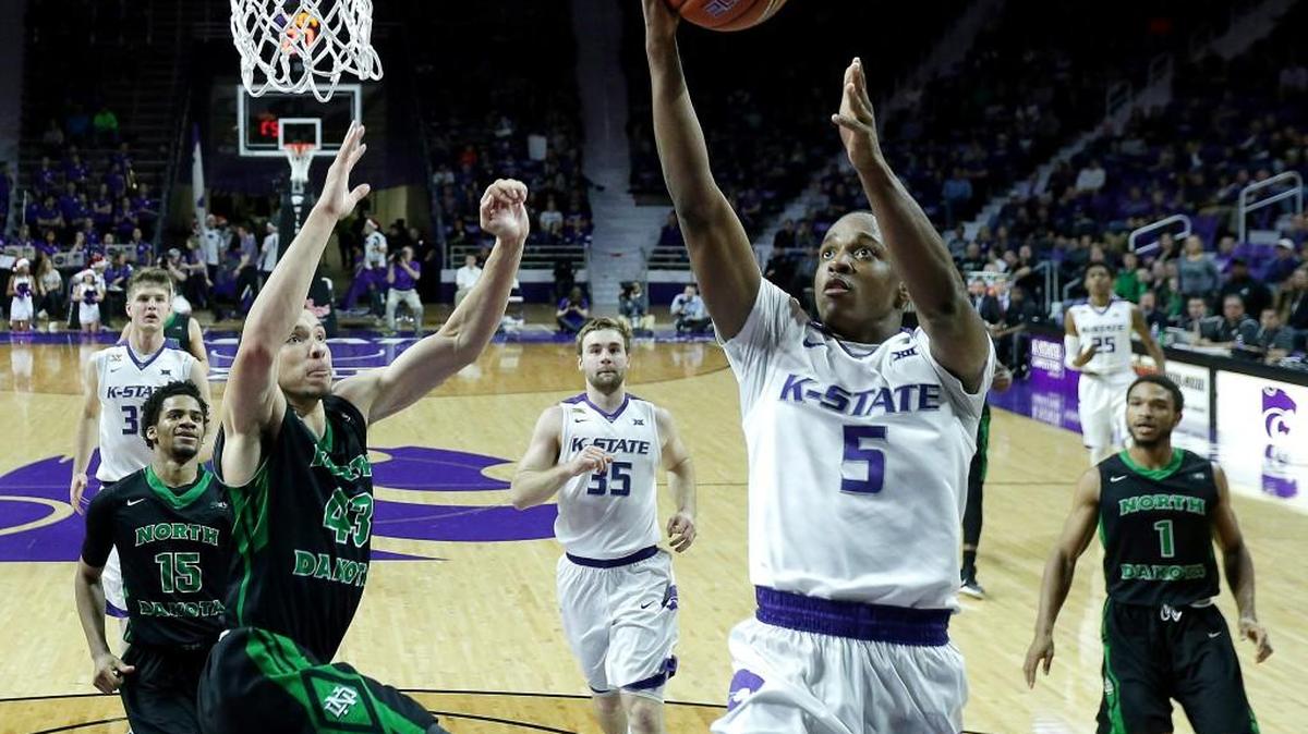 Kansas State's Barry Brown gets past North Dakota's Drick Bernstine (43) to put up a shot during the second half of an NCAA college basketball game Tuesday, Dec. 22, 2015, in Manhattan. Kansas State won 63-49. (AP Photo/Charlie Riedel)