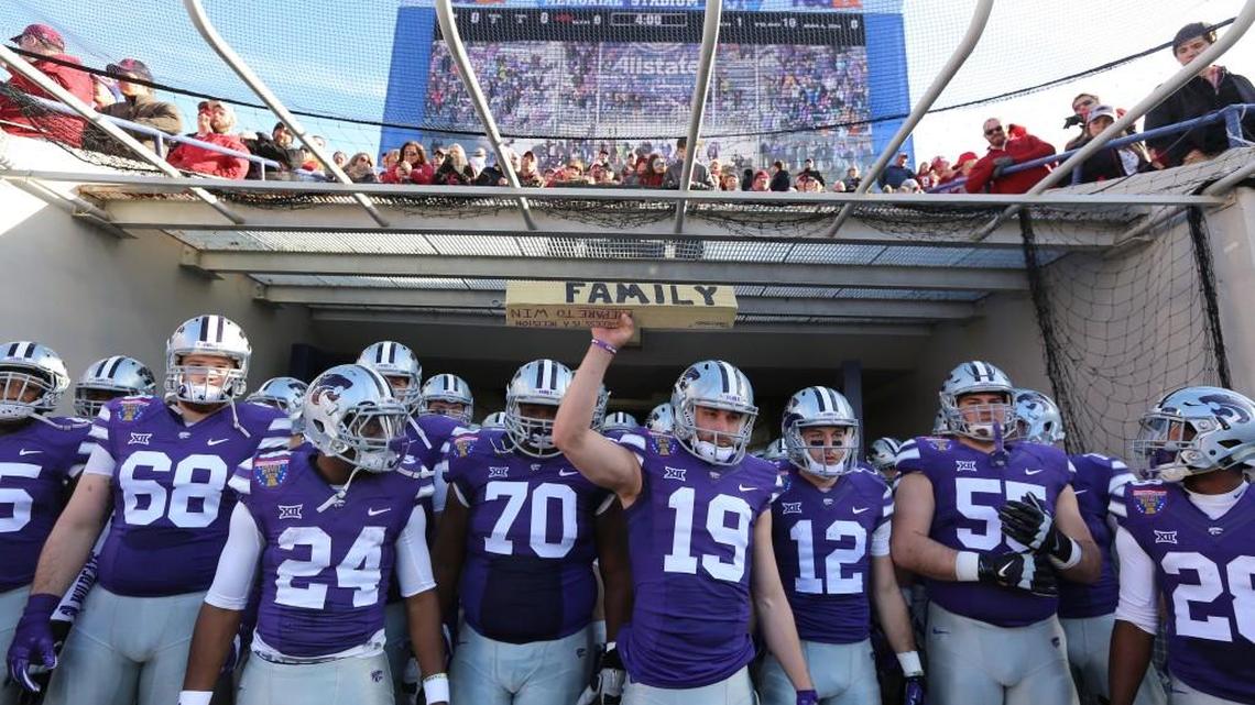K-State quarterback Kody Cook leads his team onto the field against Arkansas in the Liberty Bowl. (January 2, 2016)