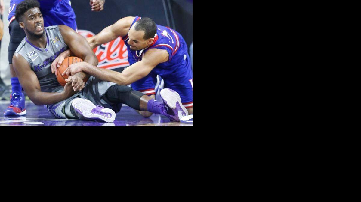 
K-State forward Nino Williams (11) battles with Kansas forward Perry Ellis (34) for a rebound under the K-State basket in Manhattan Monday night(February 23, 2015) 

