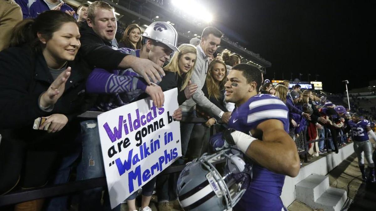 Kansas State’s Morgan Burns (33) celebrates with fans as the Wildcats celebrated defeating West Virginia 24-23 Saturday in Manhattan. Burns had a 97-yard game-winning kickoff return.