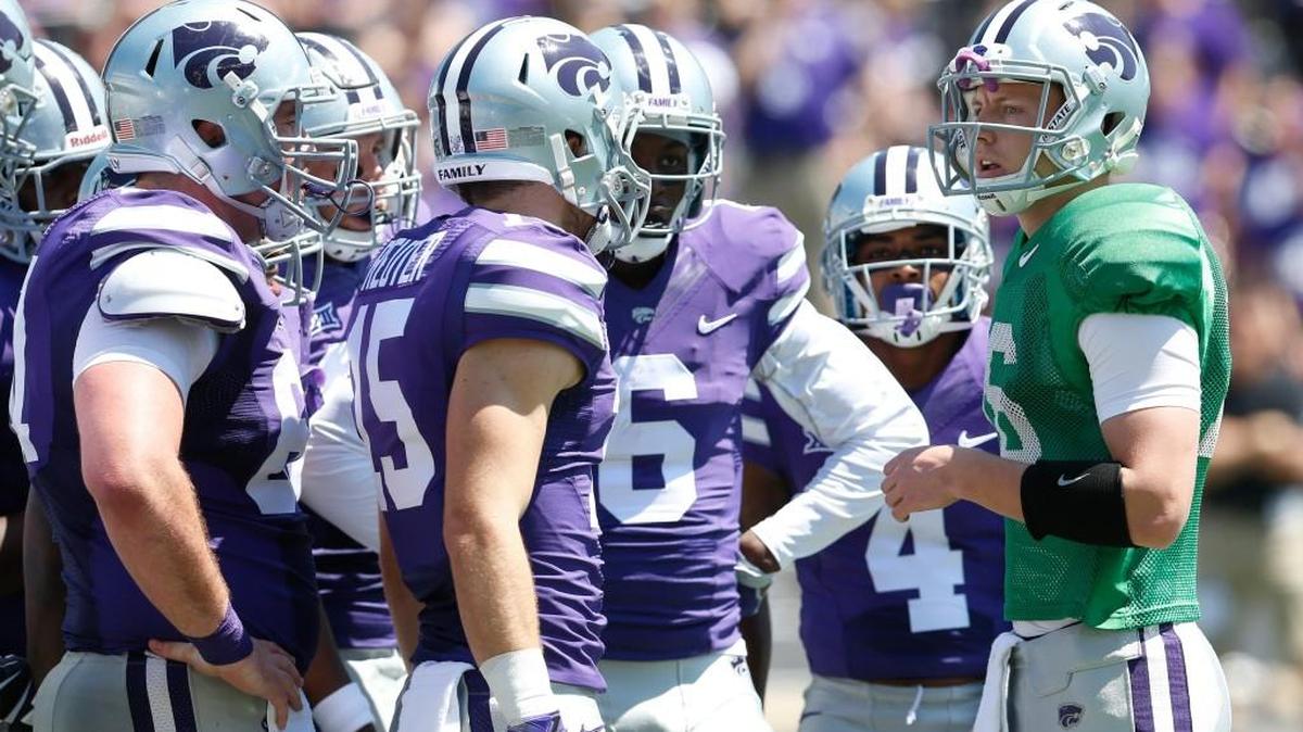 K-State quarterback Jesse Ertz huddles with the purple offense at Kansas State’s spring game in Manhattan. (April 23, 2016)