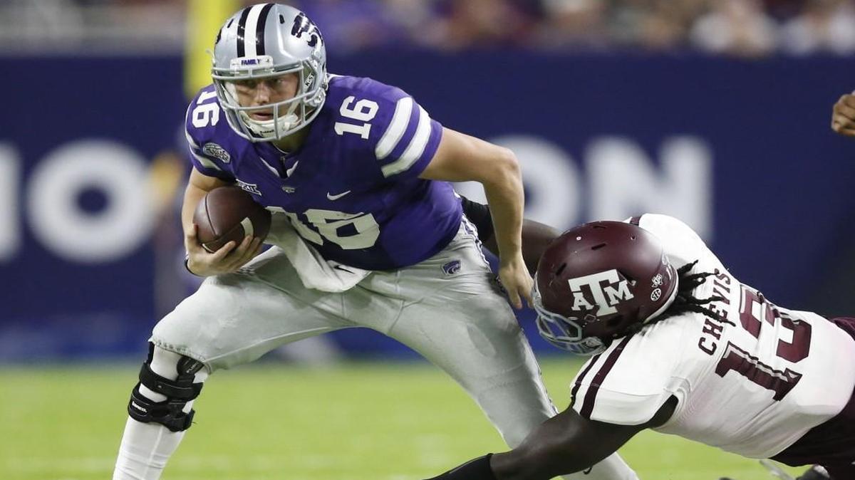 K-State quarterback Jesse Ertz (16) tries to get away from Texas A&M defensive lineman Reggie Chevis (13) in the second quarter Wednesday night in Houston.
