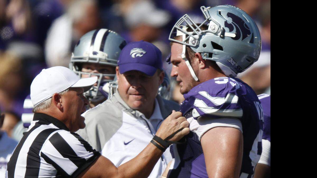 
K-State offensive lineman Cody Whitehair, right, listens to the referee during a timeout last October against Texas.
