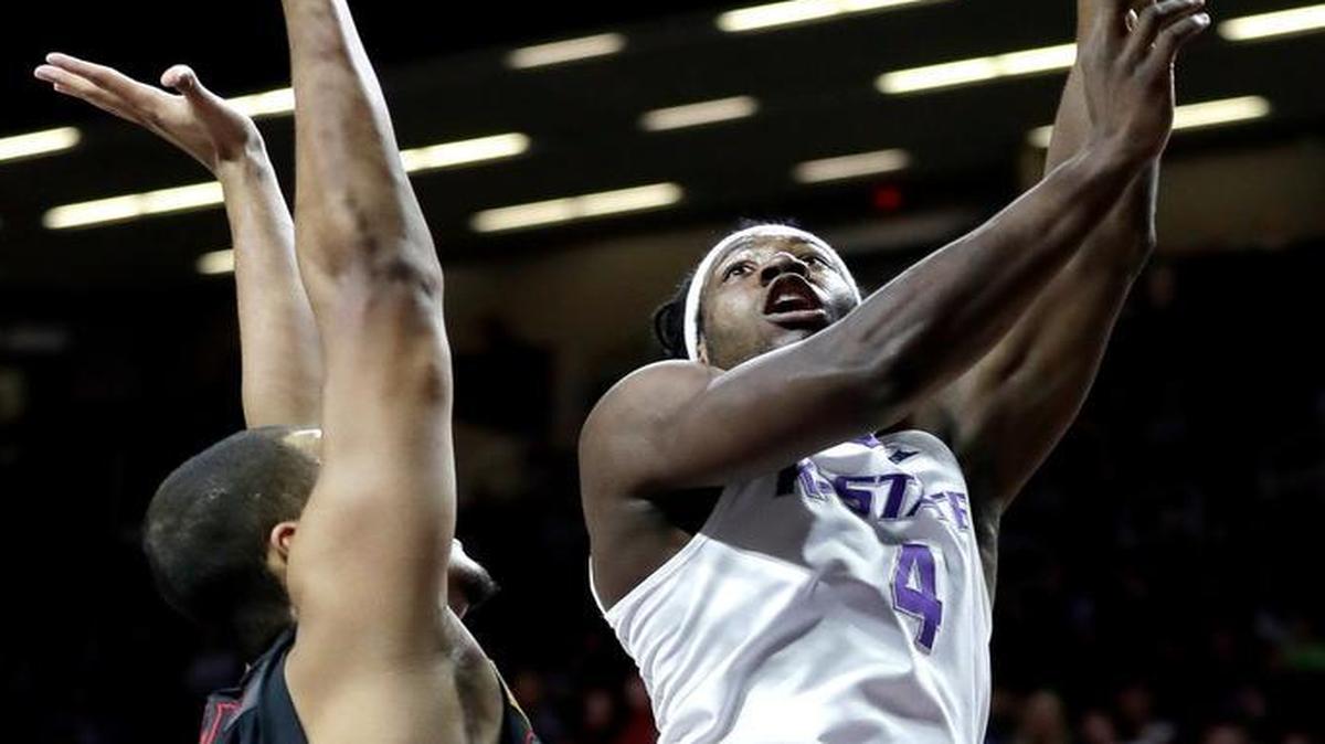 Kansas State’s D.J. Johnson (4) shoots under pressure from Gardner-Webb’s Brandon Miller during the first half Wednesday in Manhattan.