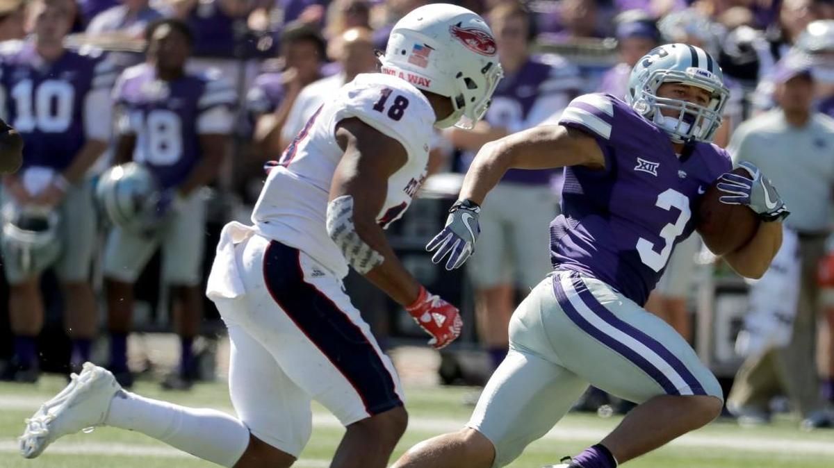 Kansas State running back Dalvin Warmackgets past Florida Atlantic safety Jalen Young as he runs for a first down during the first half Saturday,
