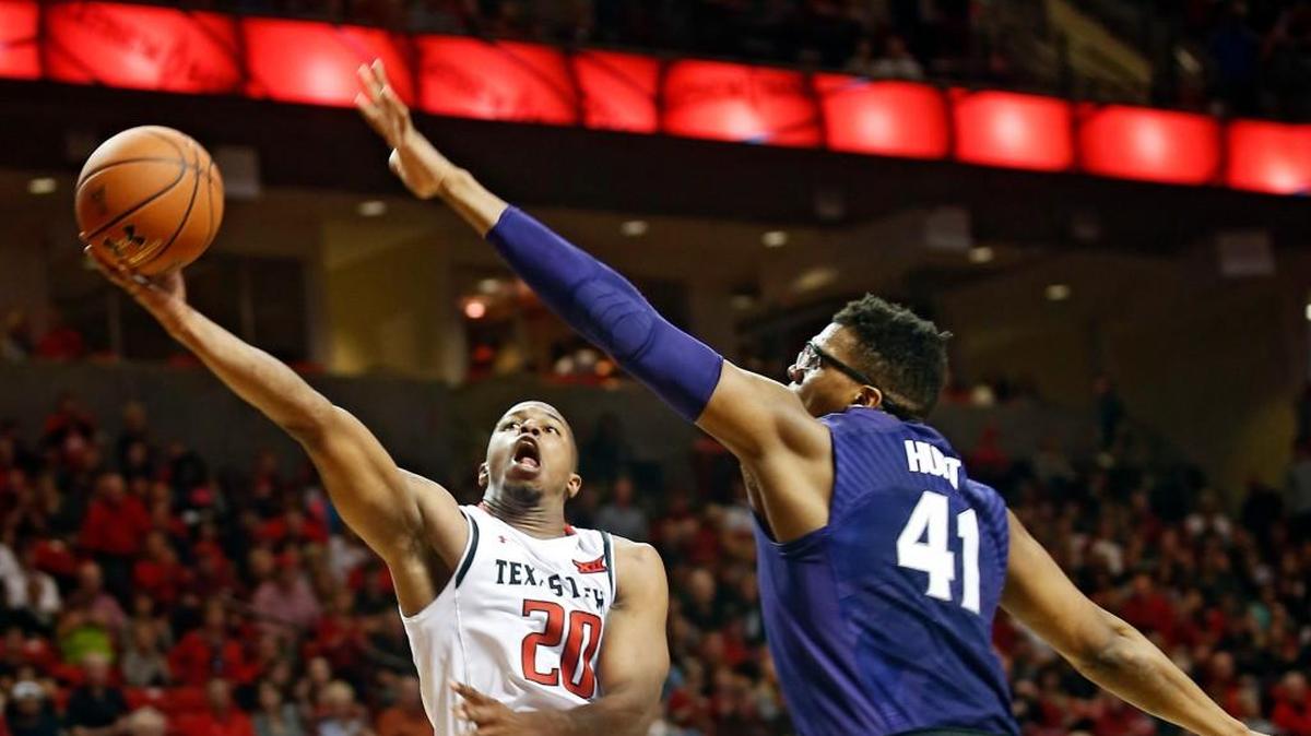 Texas Tech's Toddrick Gotcher, left, lays up the ball past Kansas State's Stephen Hurt on Saturday.