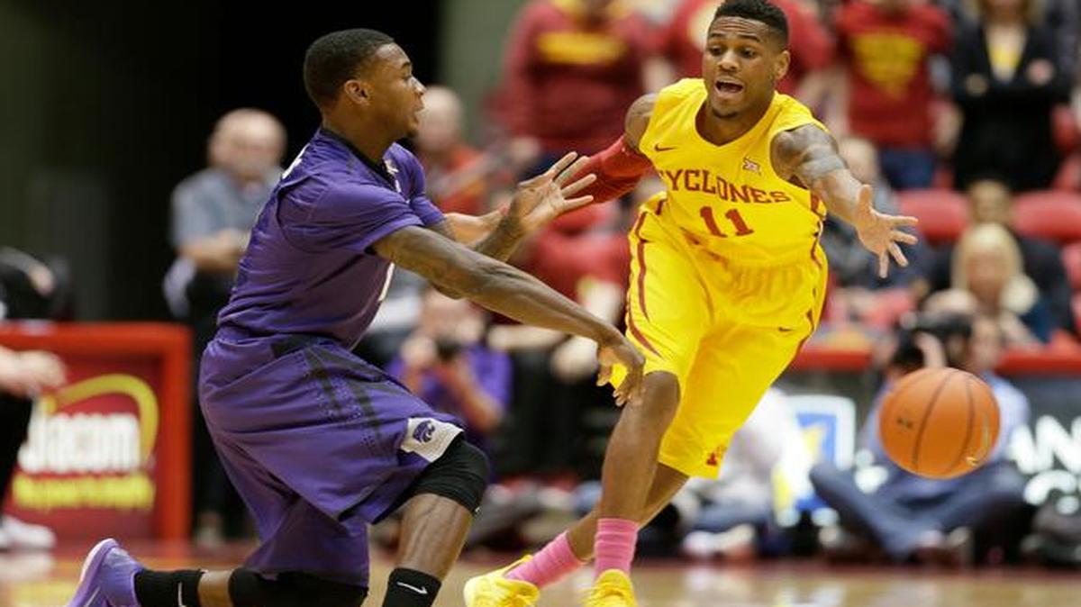 
Kansas State guard Jevon Thomas, left, passes in front of Iowa State guard Monte Morris during the first half Tuesday in Ames, Iowa.
