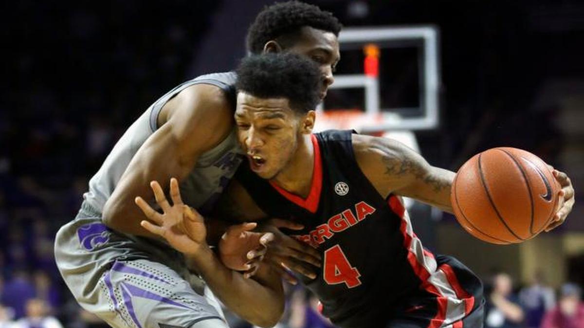 
Georgia guard Charles Mann is fouled by Kansas State guard Wesley Iwundu during the first half Wednesday in Manhattan.
