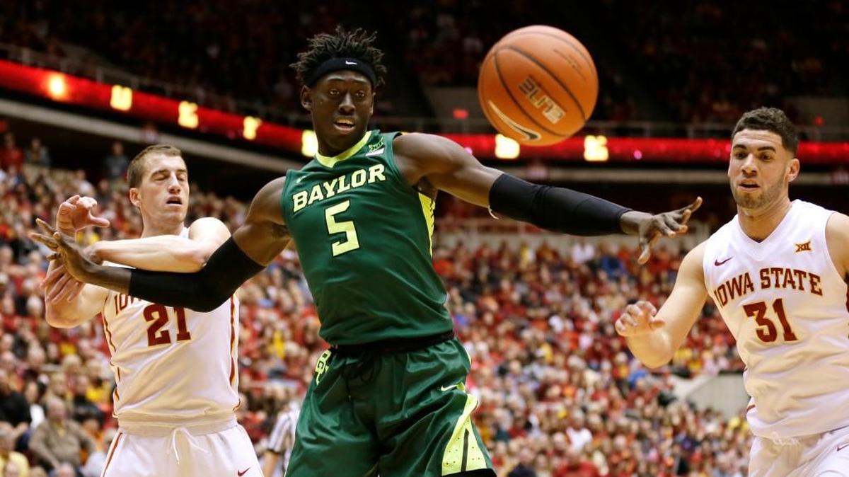 Baylor forward Johnathan Motley fights for a loose ball with Iowa State's Matt Thomas, left, and Georges Niang, right, on Saturday in Ames, Iowa.