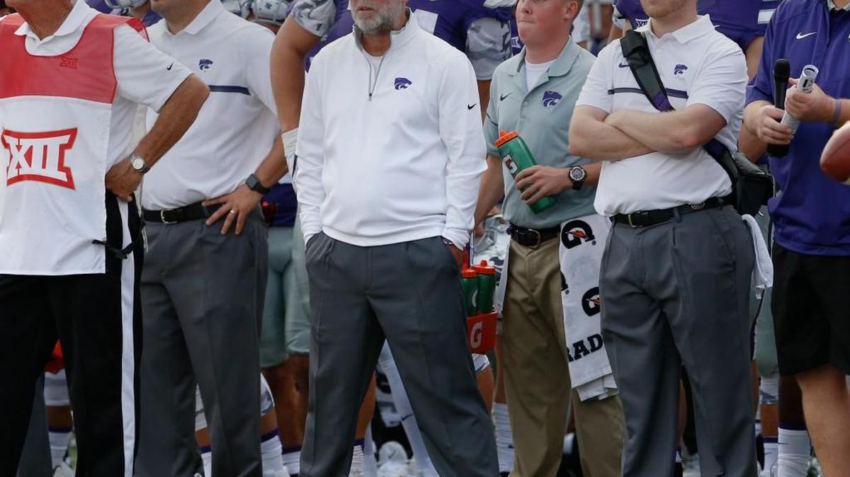 Jerry Kill (center) watchs K-State take on Oklahoma State Saturday. The former Minnesota head coach is expected to become the new offensive coordinator at Rutgers.(November 5, 2016)
