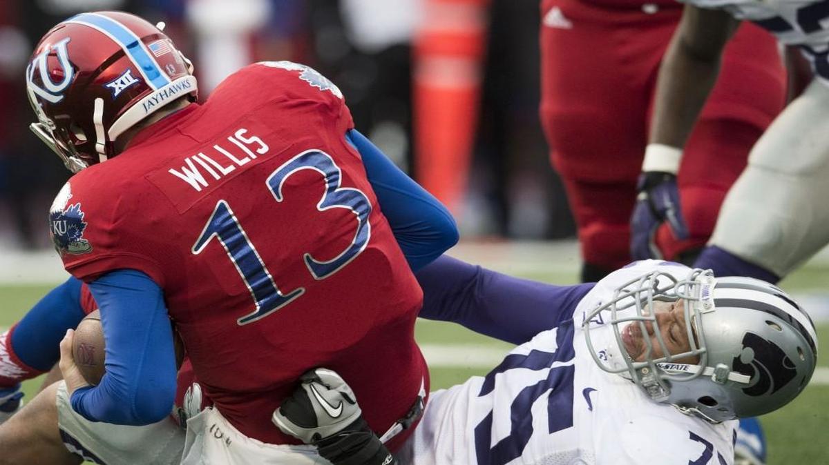 Kansas quarterback Ryan Willis is sacked by Kansas State defensive end Jordan Willis during Saturday’s game at Memorial Stadium in Lawrence.