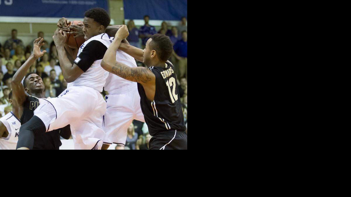 
Kansas State guard Wesley Iwundu, center, battles for a rebound with Purdue guard Jon Octeus, left, and Purdue's forward Vince Edwards (12) in the second half.

