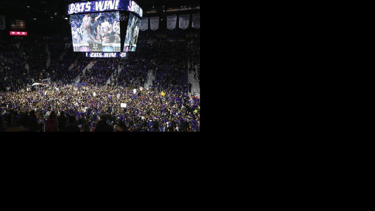 
K-State fans rush the court Monday night in Manhattan as K-State defeated 8th ranked Kansas 70-63. Its the second straight year Kansas was handed a loss in Manhattan.(February 23, 2015) 
