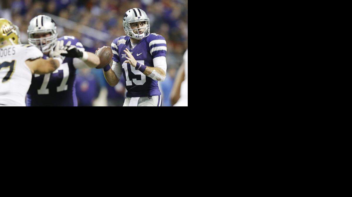 
Kansas State quarterback Jake Waters looks for a receiver during the first half of the Alamo Bowl on Friday night.
