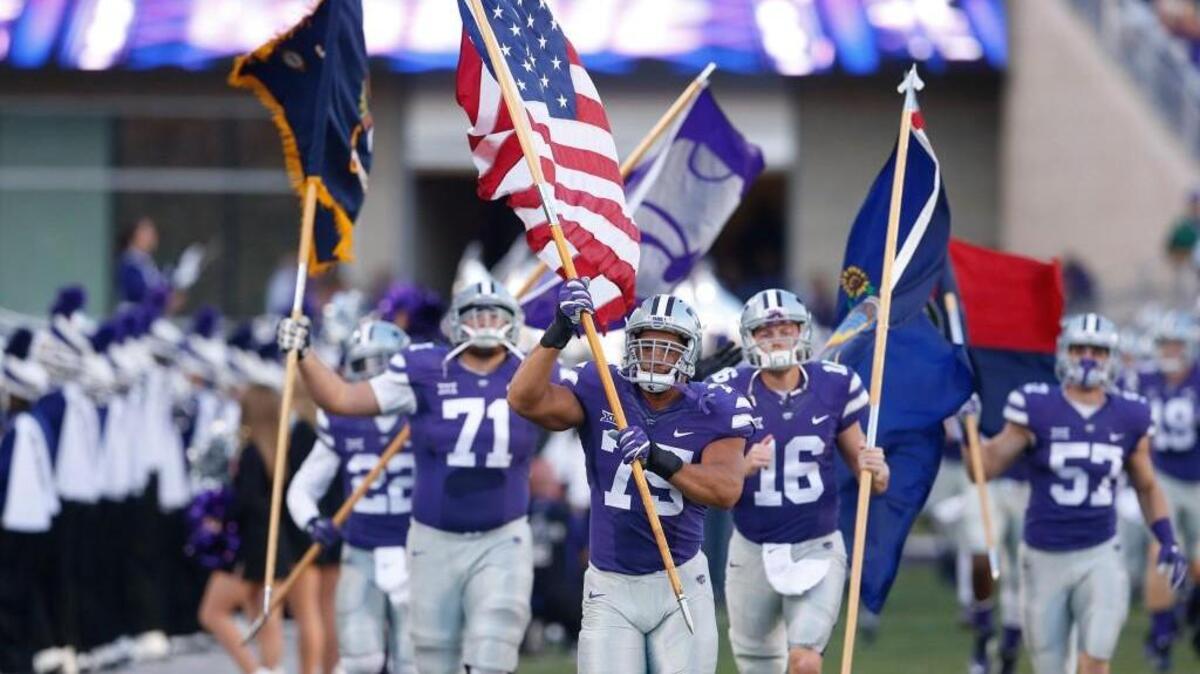 K-State players, lead by K-State defensive end Jordan Willis run on to the field. (October 8, 2016)