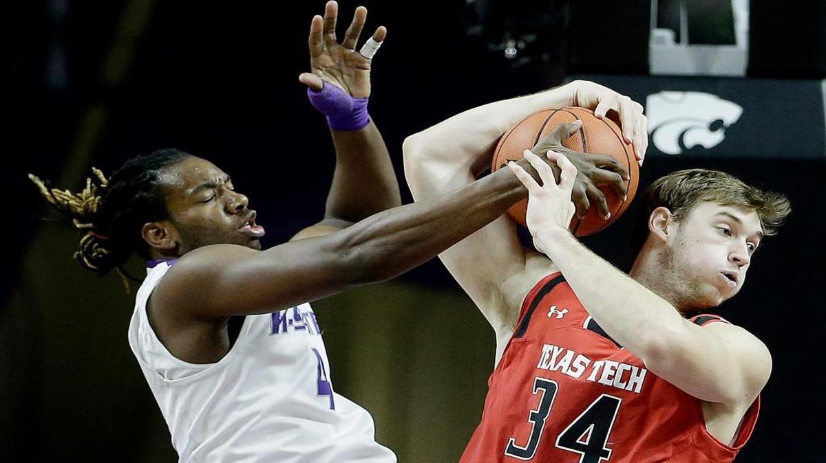 Kansas State's D.J. Johnson, left, battles for the ball with Texas Tech's Matthew Temple during the first half Tuesday in Manhattan.