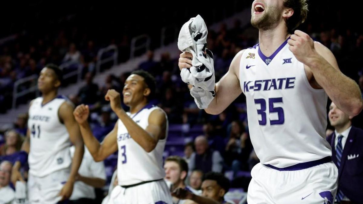 The Kansas State bench celebrates a teammate's basket against South Dakota. (AP Photo/Charlie Riedel)