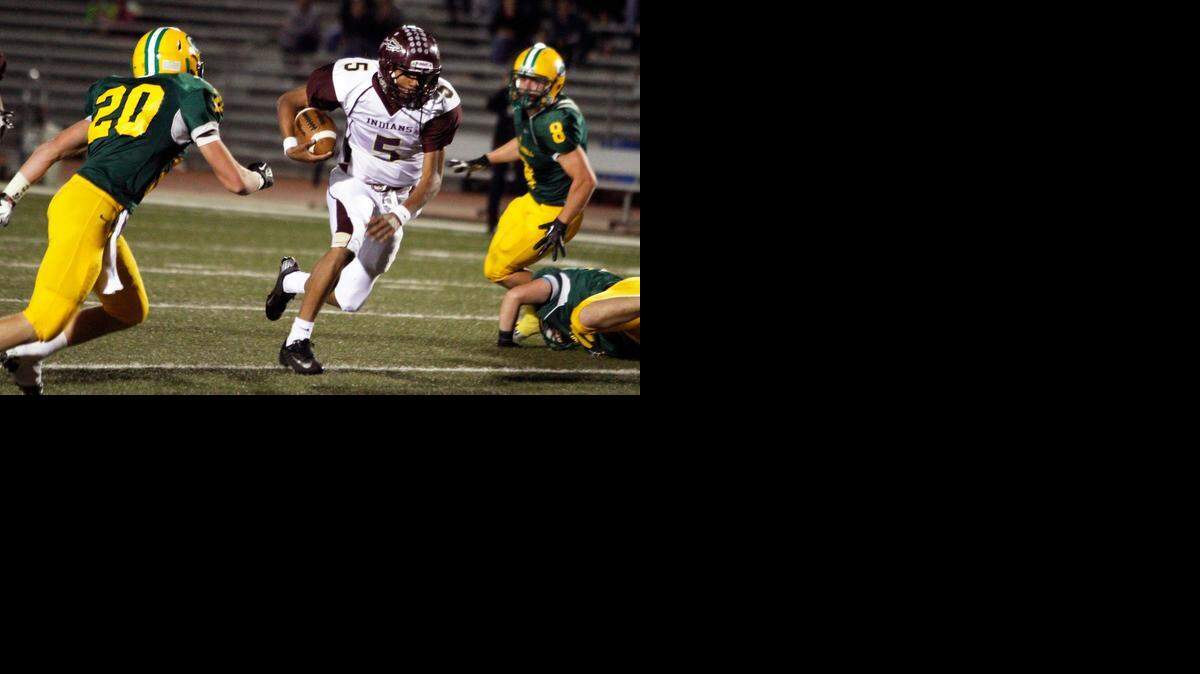 
Hays quarterback Alex Delton runs through a hole against Carroll.
