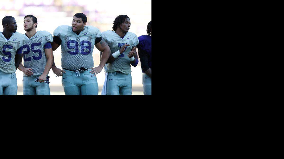 
K-State defensive tackle Terrell Clinkscales stands between teammates during a practice last summer.

