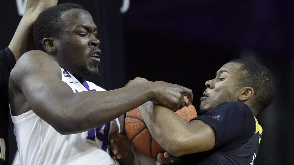 Kansas State forward Makol Mawien, left, rebounds against Southern Mississippi guard Kevin Holland during the first half Wednesday in Manhattan.