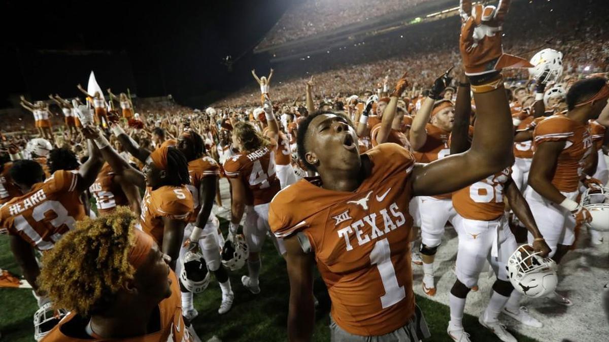 Texas wide receiver John Burt celebrates with teammates after they defeated Notre Dame in double overtime in a NCAA college football game, Sunday, Sept. 4, 2016, in Austin, Texas. Texas won 50-47. (AP Photo/Eric Gay)