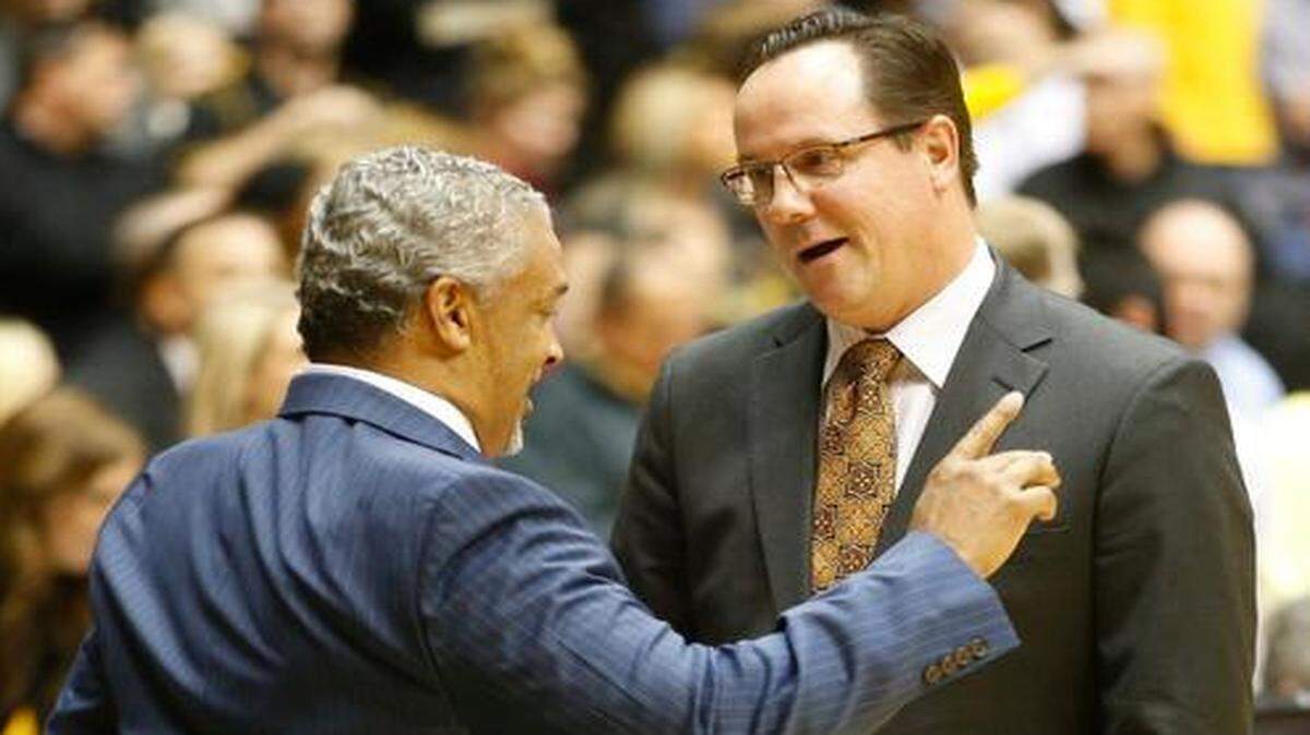 
New Mexico State coach Marvin Menzies talks with Wichita State's Gregg Marshall before the teams played at Koch Arena in November.
