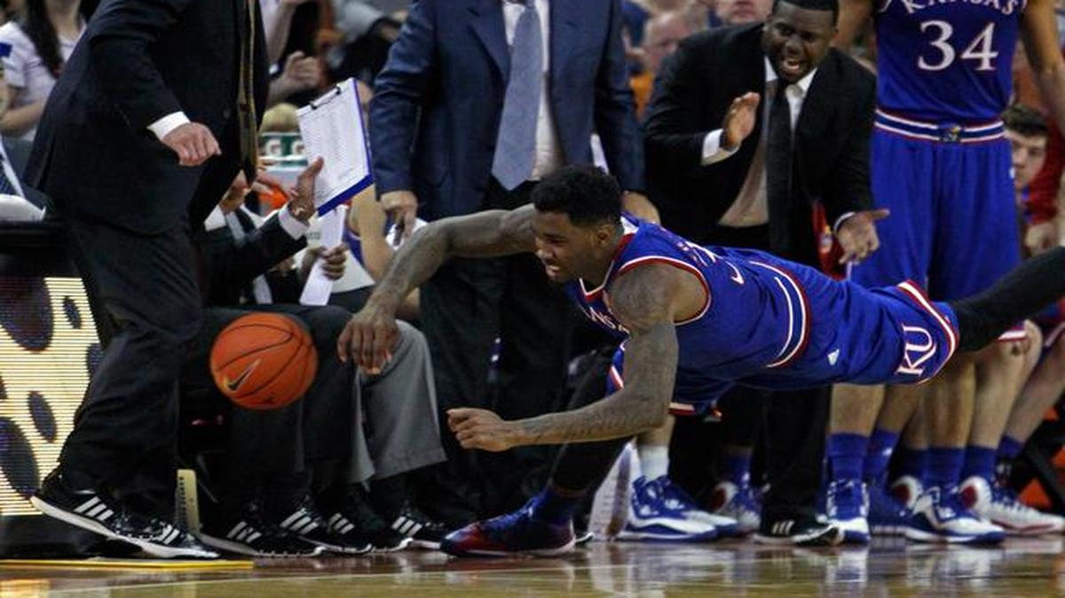 
Kansas’ Jamari Traylor dives for a loose ball during the first half against Texas on Saturday in Austin.
