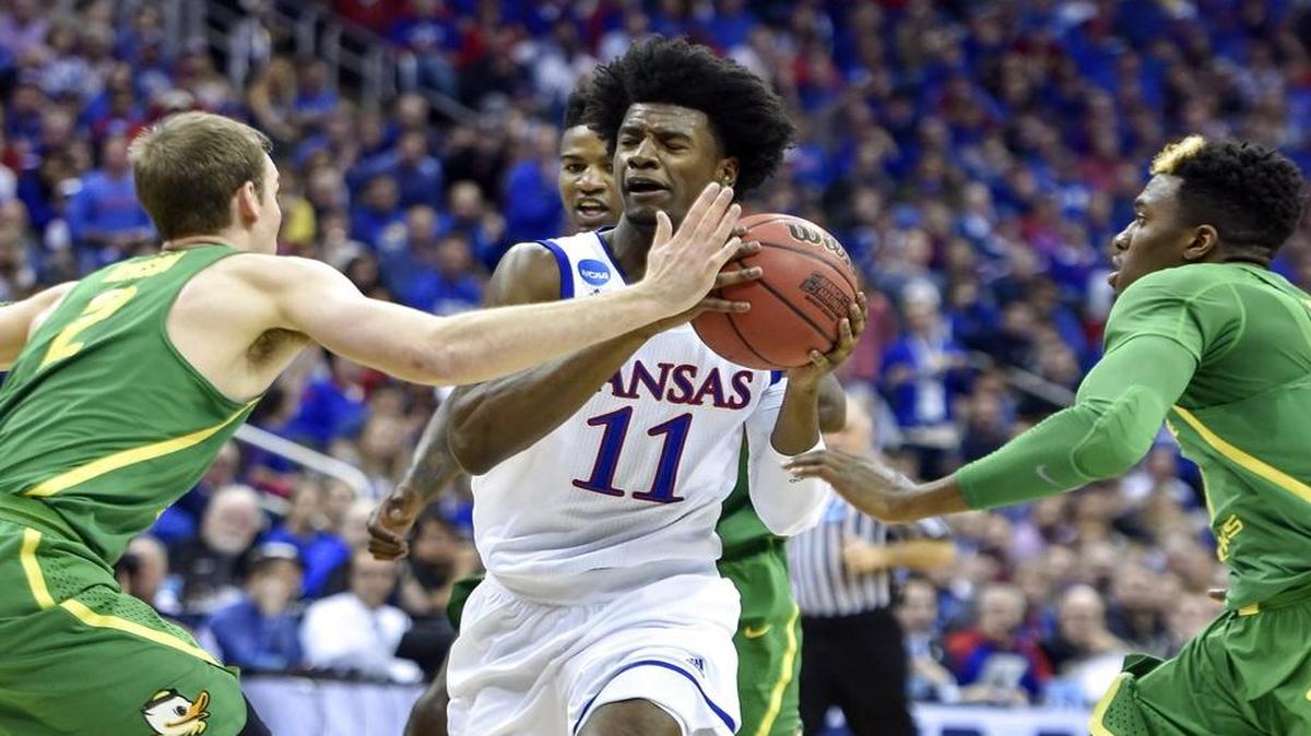 Kansas guard Josh Jackson drives to the basket against Oregon's Casey Benson in the first half Saturday.