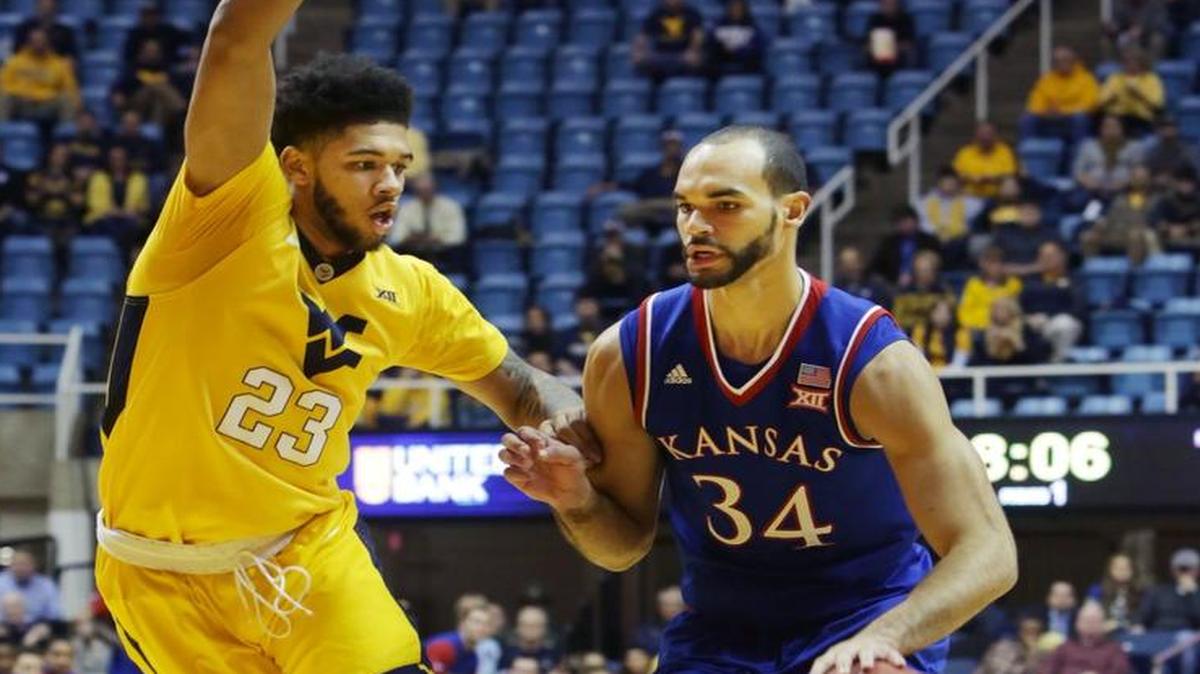 Kansas forward Perry Ellis drives against West Virginia’s Esa Ahmad on Tuesday.