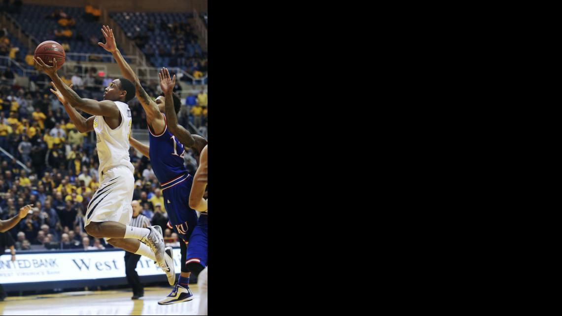 
West Virginia guard Juwan Staten (3) drives past Kansas guard Kelly Oubre Jr. (12) to score the game winning basket in the final seconds of Monday’s game in Morgantown, W.Va. West Virginia defeated Kansas 62-61.
