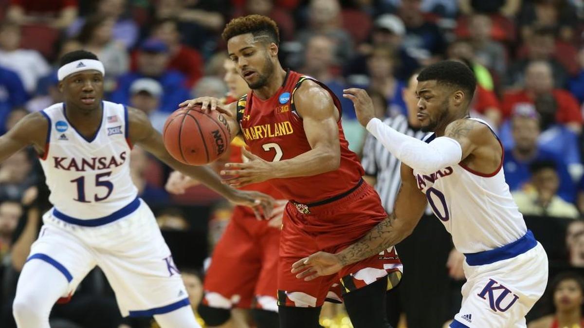 Maryland guard Melo Trimble is guarded by Kansas guard Frank Mason, right, during the second half Thursday night in Louisville.