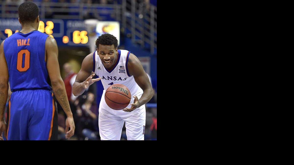
KU's Wayne Selden Jr. (right) who led all scorers with 21 points, looked to the KU bench as time expired on Kasey Hill (0) and the Florida Gators Friday night at Allen Fieldhouse. After trailing by 15 at the break, KU came back to win, 71-65.
