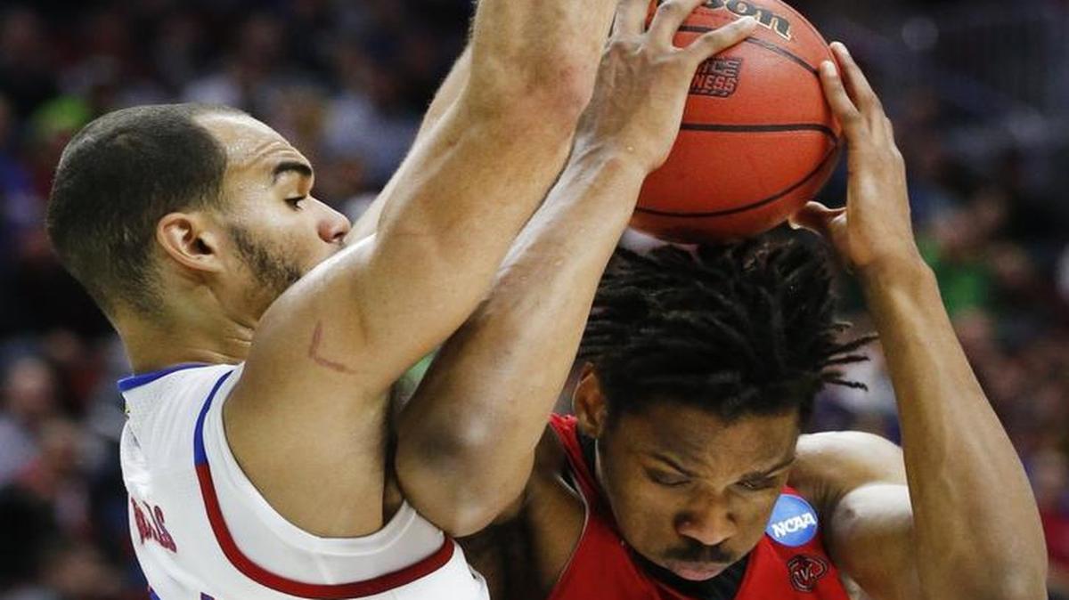 Kansas’ Perry Ellis blocks Austin Peay’s Josh Robinson from the basket Thursday afternoon in the first round of the NCAA Tournament.