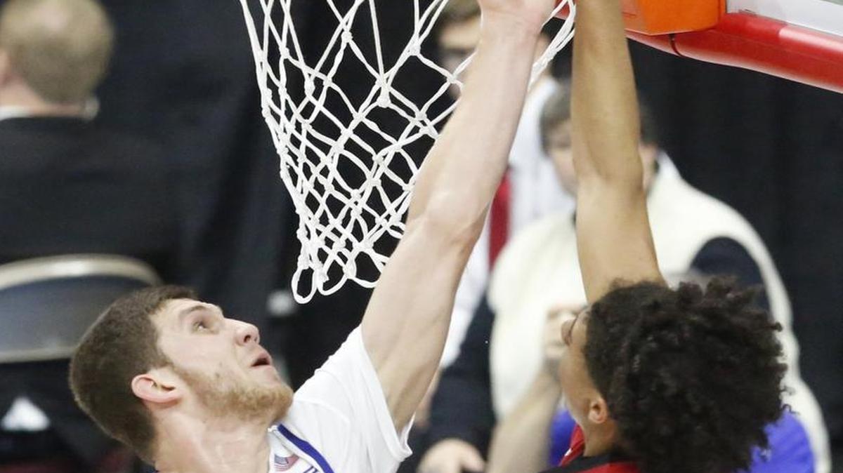 Kansas guard Sviatoslav Mykhailiuk (10) tries to stop a shot by Austin Peay guard Jared Savage during Thursday’s first-round game. KU won 105-79 but the Jayhawks were largely unhappy with their defense.